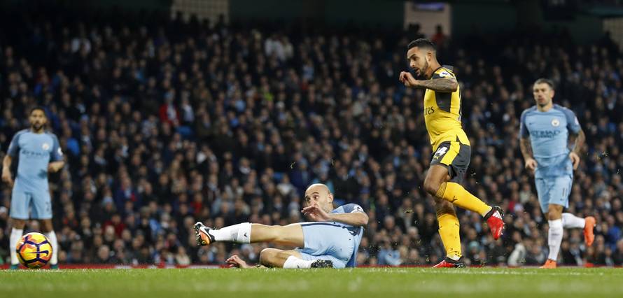 Arsenal's Theo Walcott scores their first goal