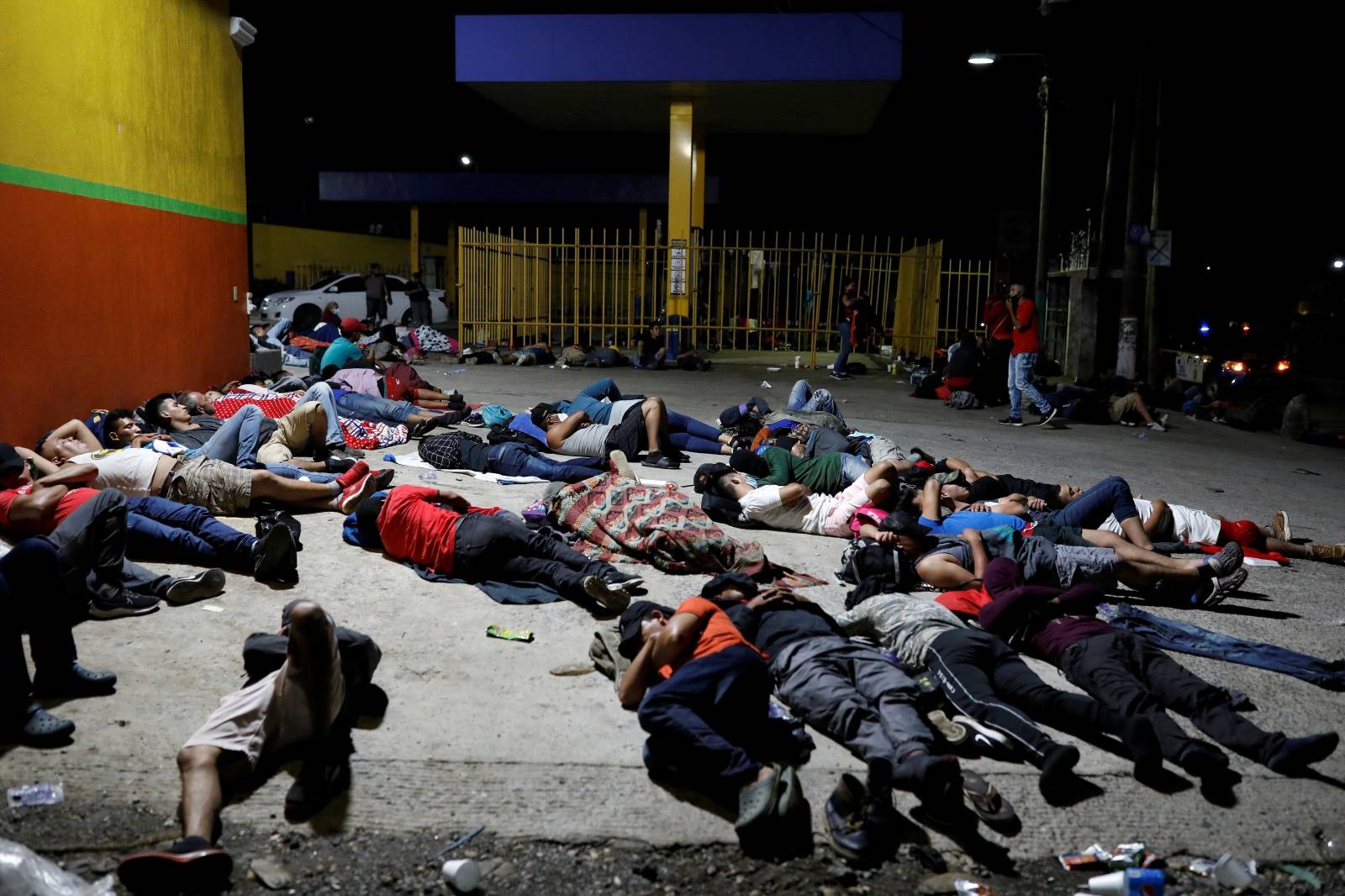Honduran migrants trying to reach the U.S. sleep on the floor after a long day of walking in the town of Entre Rios
