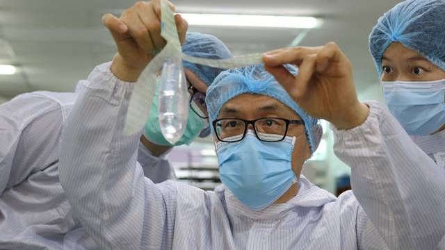  John Tang Ing Ching, founder and inventor of Wondaleaf Unisex Condom inspects the unisex condom at his factory in Sibu