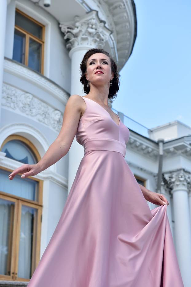 beautiful elegant brunette woman in pink dress