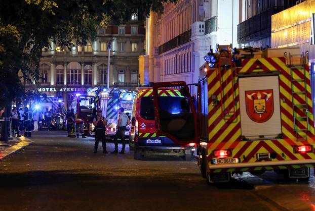 First responders work at the site of a funicular accident in Lisbon