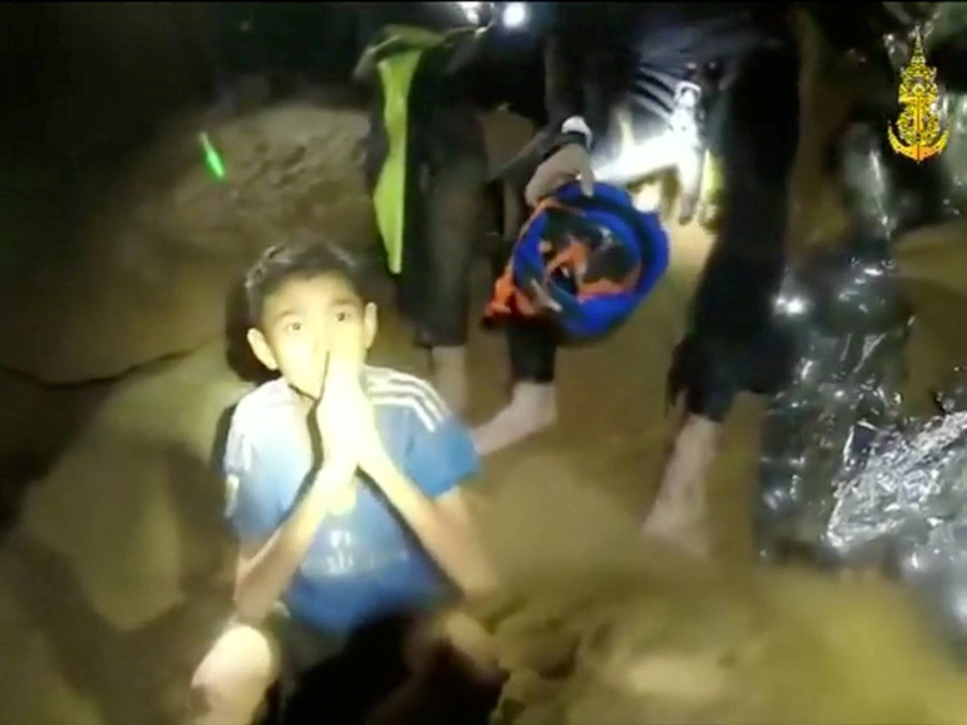 Boys from the under-16 soccer team trapped inside Tham Luang cave greet members of the Thai rescue team in Chiang Rai, Thailand