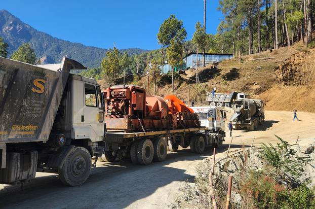 A new auger machine arrives at the site where road workers are trapped in a tunnel after a portion of it collapsed, in Uttarkashi