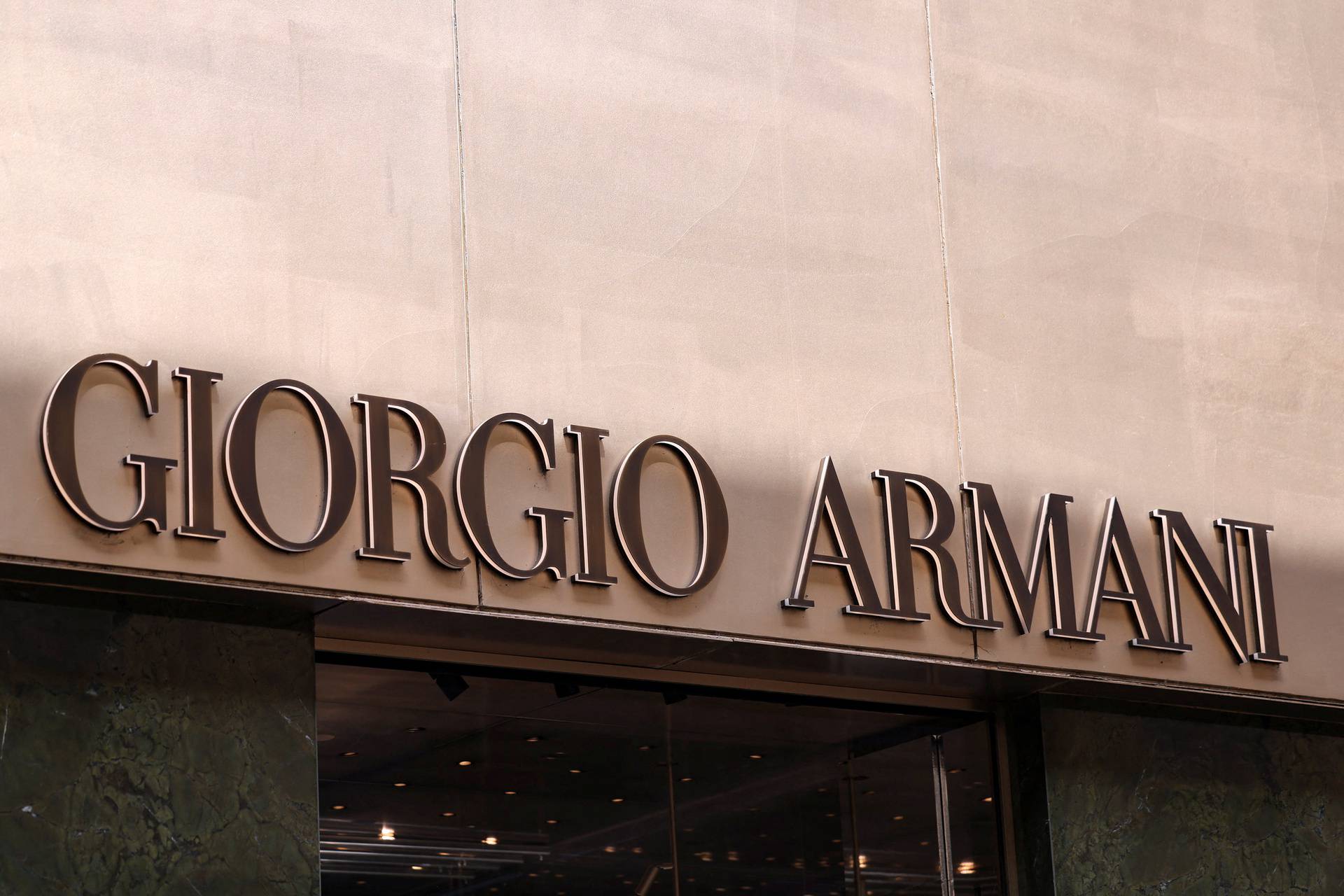 The logo of fashion house Giorgio Armani is seen outside a shop in Milan