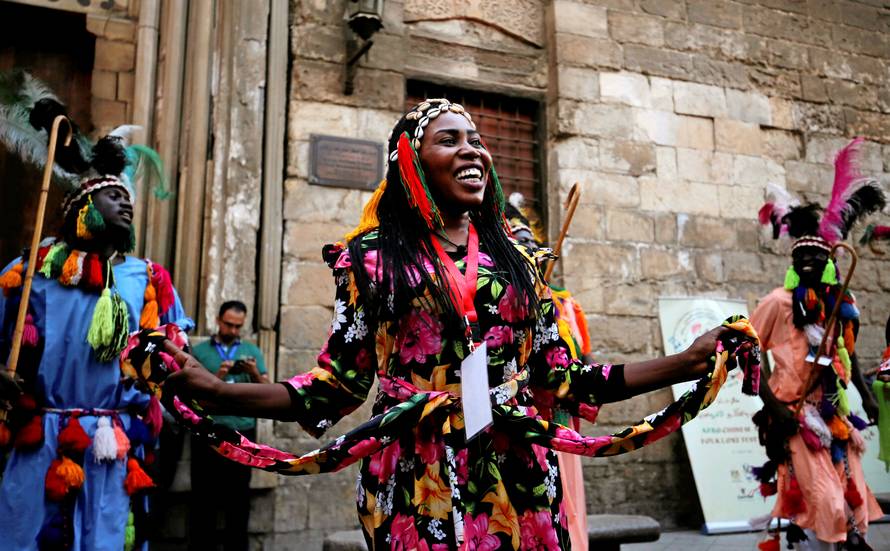 Members of a Sudanese and Eritrean dance group perform a traditional folk dance during the African-Chinese cultural festival, organised by Egypt's Ministry of Tourism, on the historic Moez Street, in Cairo