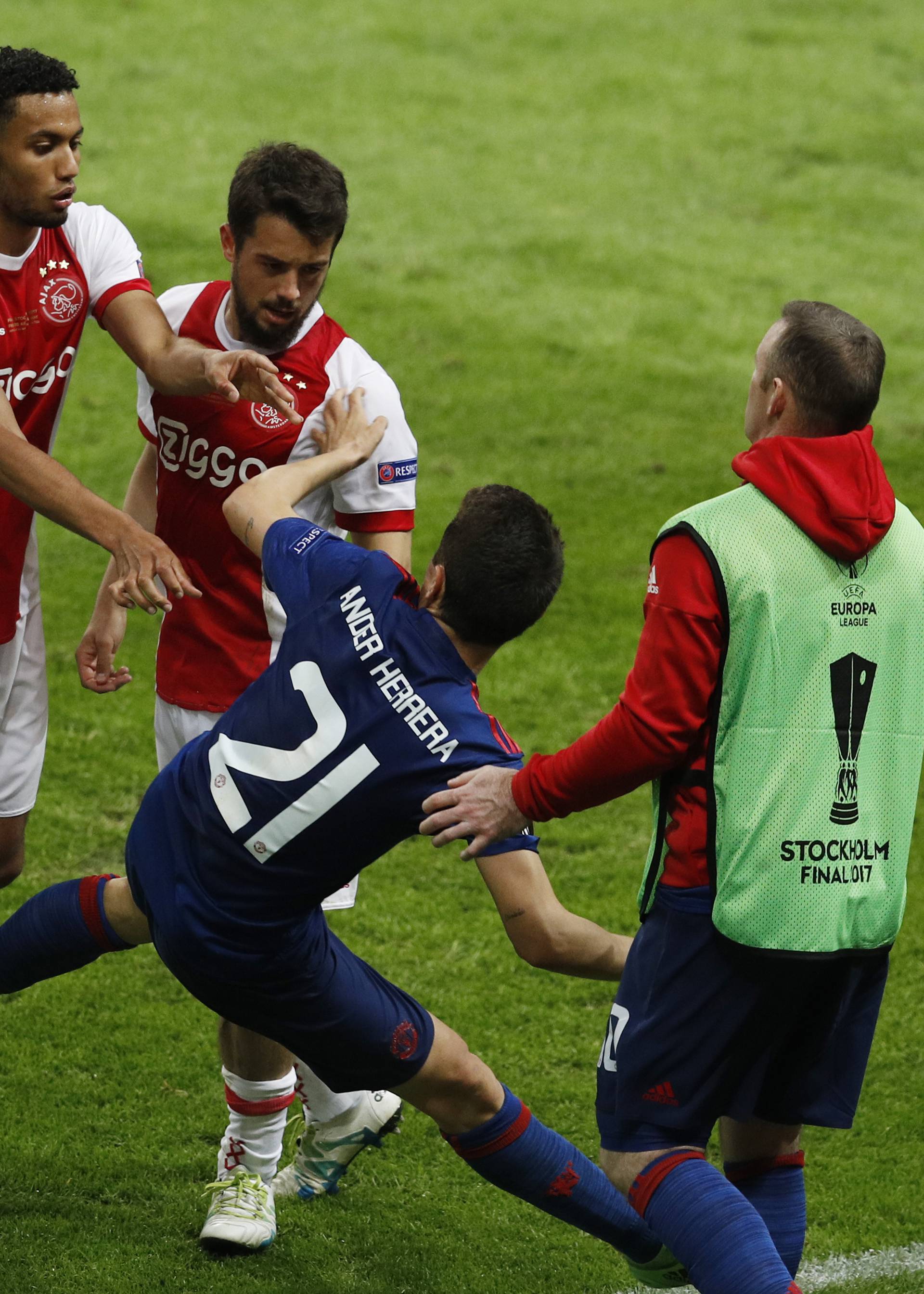 Ajax's Jairo Riedewald and Amin Younes push Manchester United's Ander Herrera