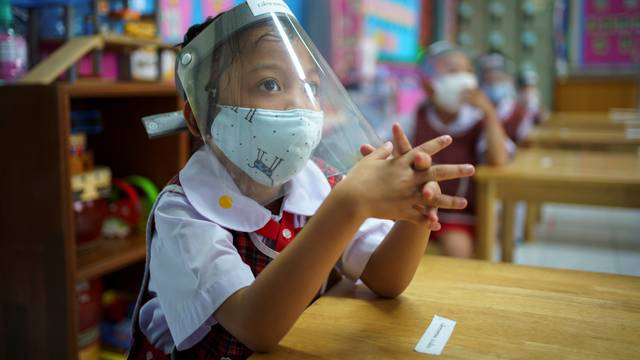 Thai kindergarten students rehearse social distancing and measures to prevent the spread of the coronavirus disease (COVID-19) in Bangkok