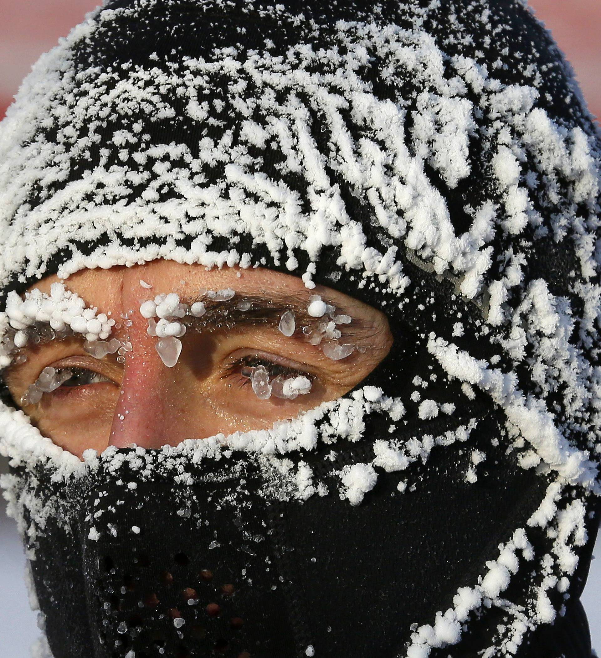 Runner with his face covered with hoarfrost competes during traditional half Marathon amateur competition marking Orthodox Christmas Day festivities in Krasnoyarsk