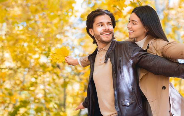 Couple in love enjoying time together in golden forest