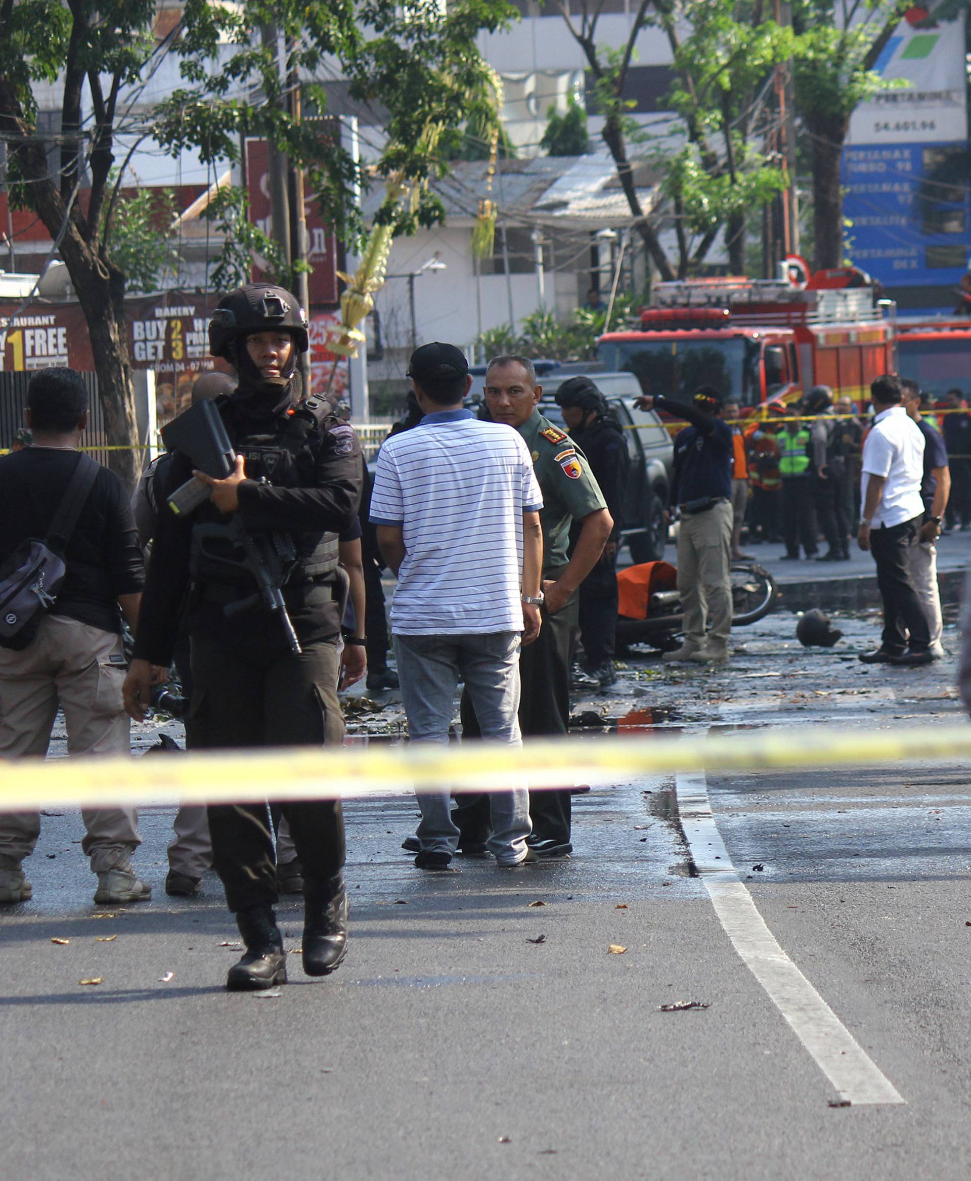 Police stand guard near the site of a blast at the Pentecost Church Central Surabaya (GPPS), in Surabaya, East Java