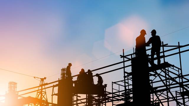 Silhouette,Of,Engineer,And,Construction,Team,Working,At,Site,Over