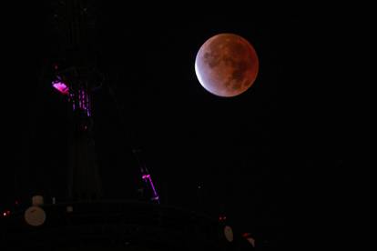 The moon undergoes a partial lunar eclipse as seen from New York City