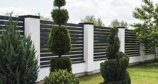 A,Fragment,Of,A,Corrugated,Board,Fence,In,A,Garden