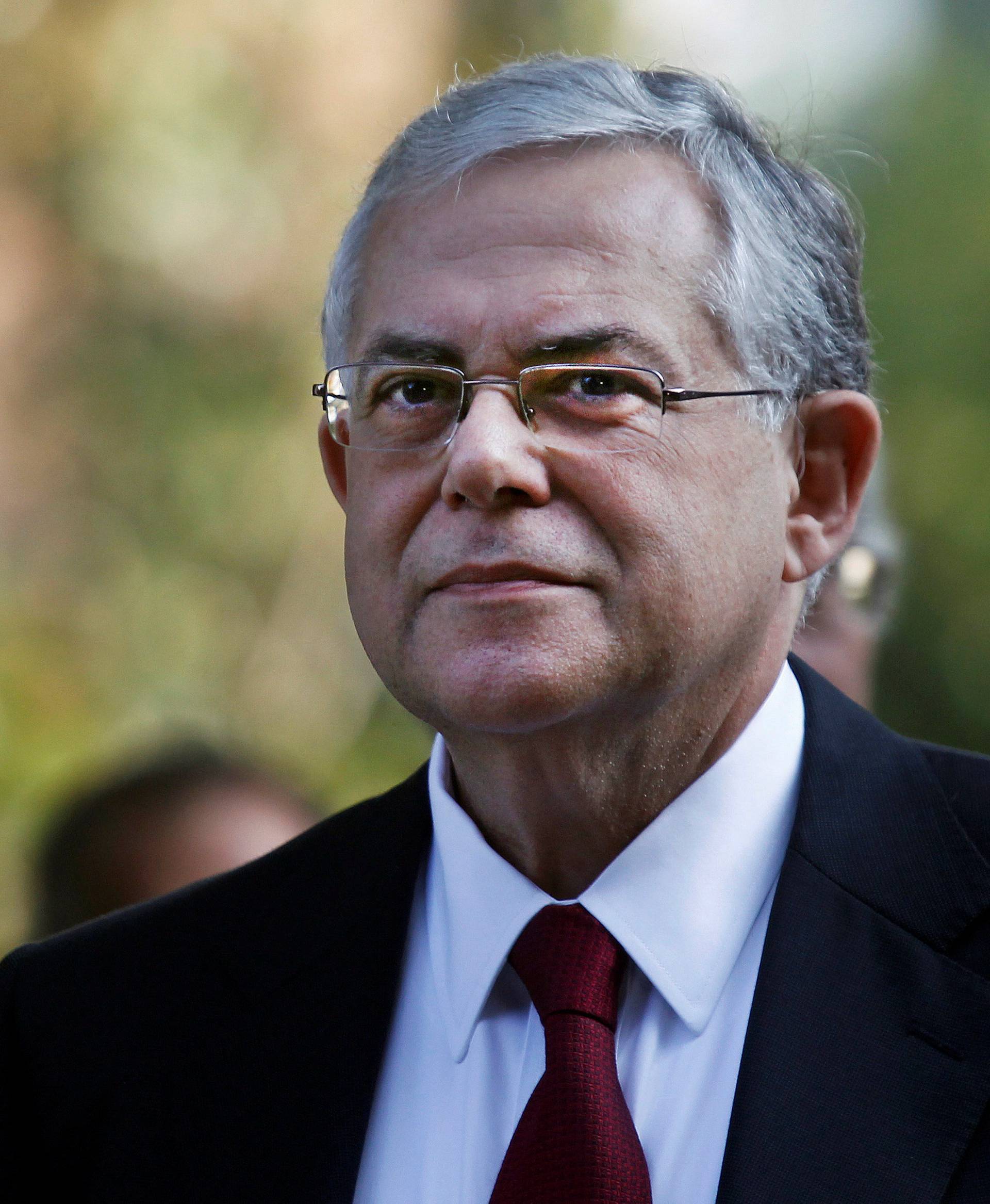 FILE PHOTO: Greece's incoming Prime Minister Lucas Papademos is seen after a meeting with Greek political leaders outside the Presidential palace in Athens