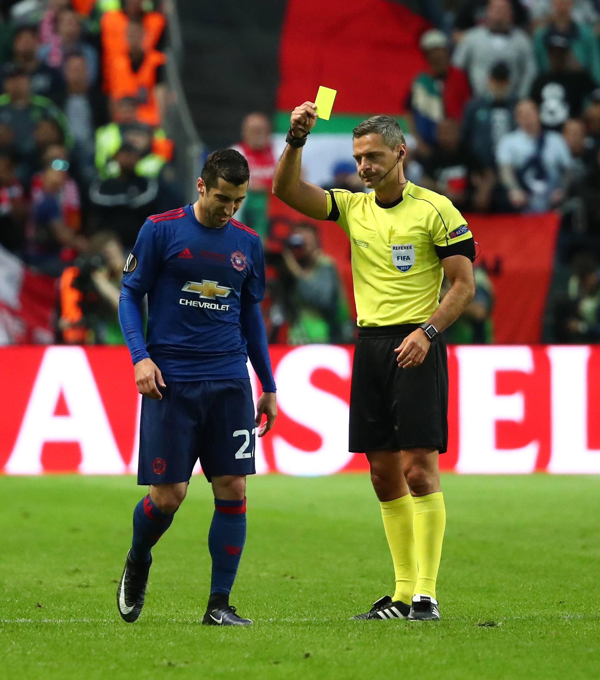 Manchester United's Henrikh Mkhitaryan is shown a yellow card by referee Damir Skomina for a foul on Ajax's Joel Veltman