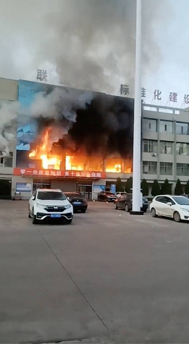 Fire burns at the Yongju Coal Industry Joint Building, in Luliang City, Shanxi province