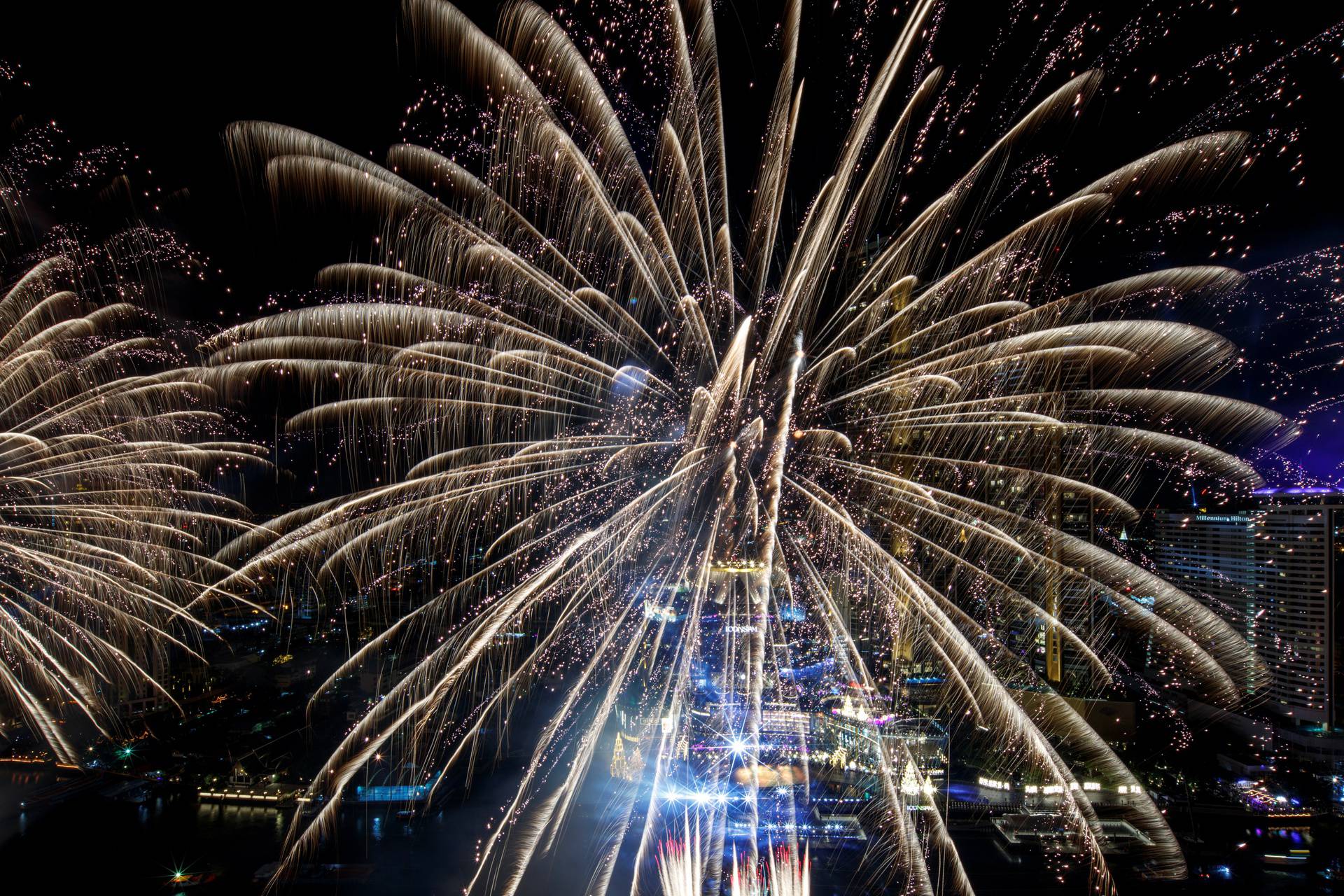 Fireworks explode over Chao Phraya River during the New Year celebrations amid the spread of the coronavirus disease (COVID-19) in Bangkok