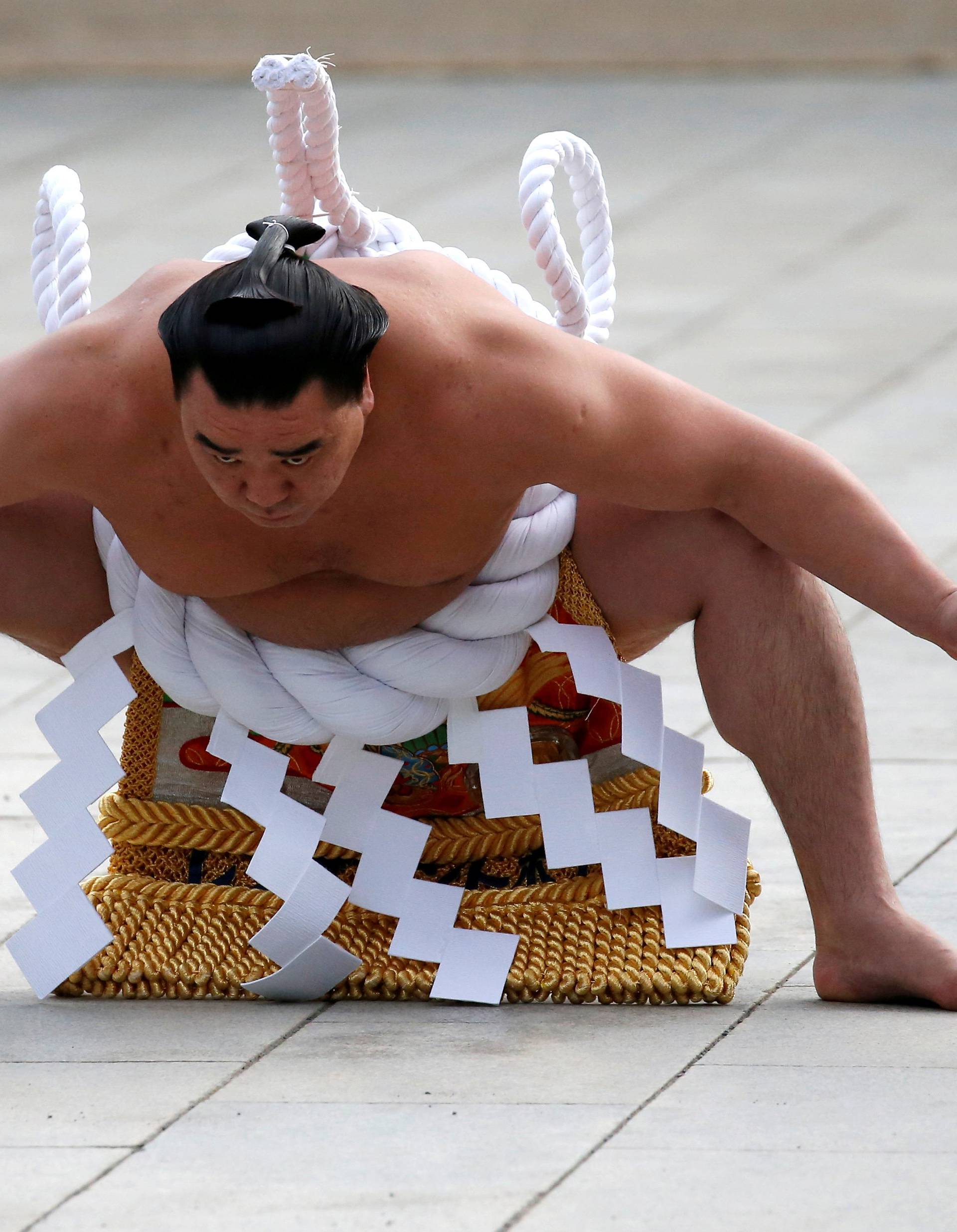 FILE PHOTO : Mongolian-born grand sumo champion Yokozuna Harumafuji performs the New Year's ring-entering rite at the annual celebration for the New Year at Meiji Shrine in Tokyo