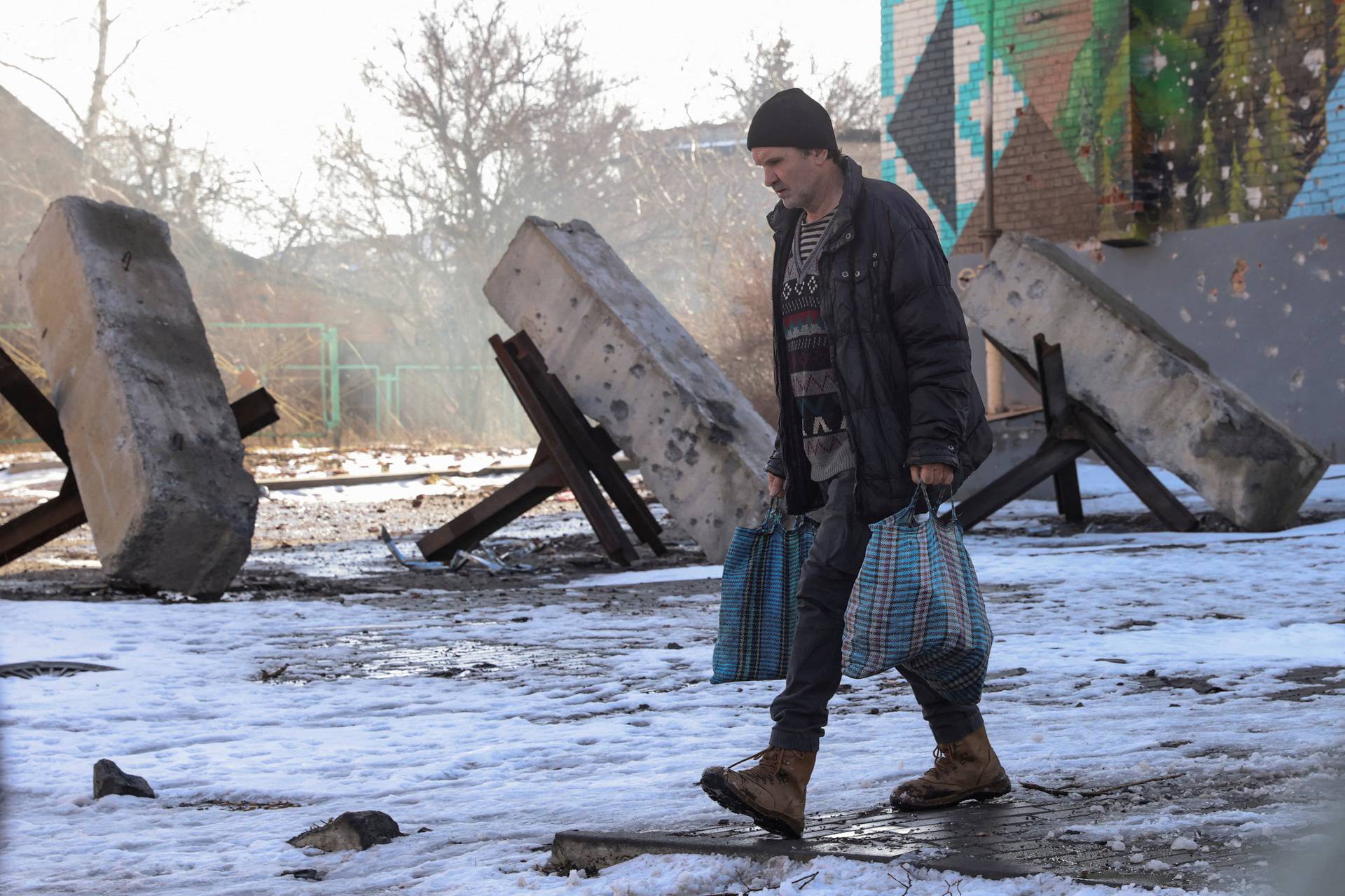 Local resident walks along a street in the frontline city of Bakhmut