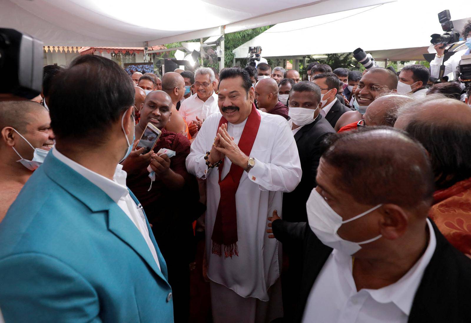 FILE PHOTO: Sri Lanka's Prime Minister Mahinda Rajapaksa gestures as he leaves after his swearing in ceremony  as the new Prime Minister, at Kelaniya Buddhist temple in Colombo