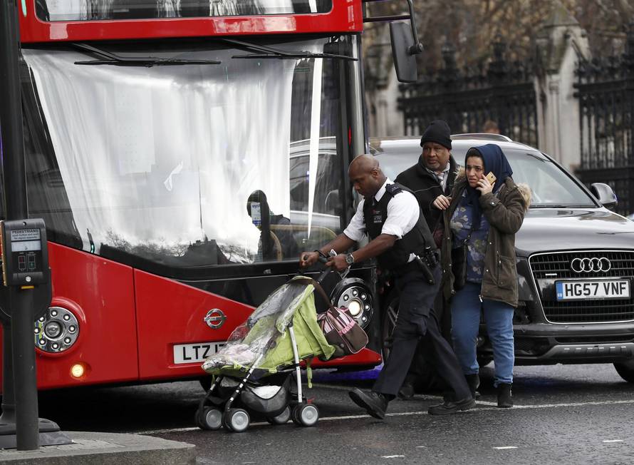 Police assist bystanders during an incident on Westminster Bridge in London