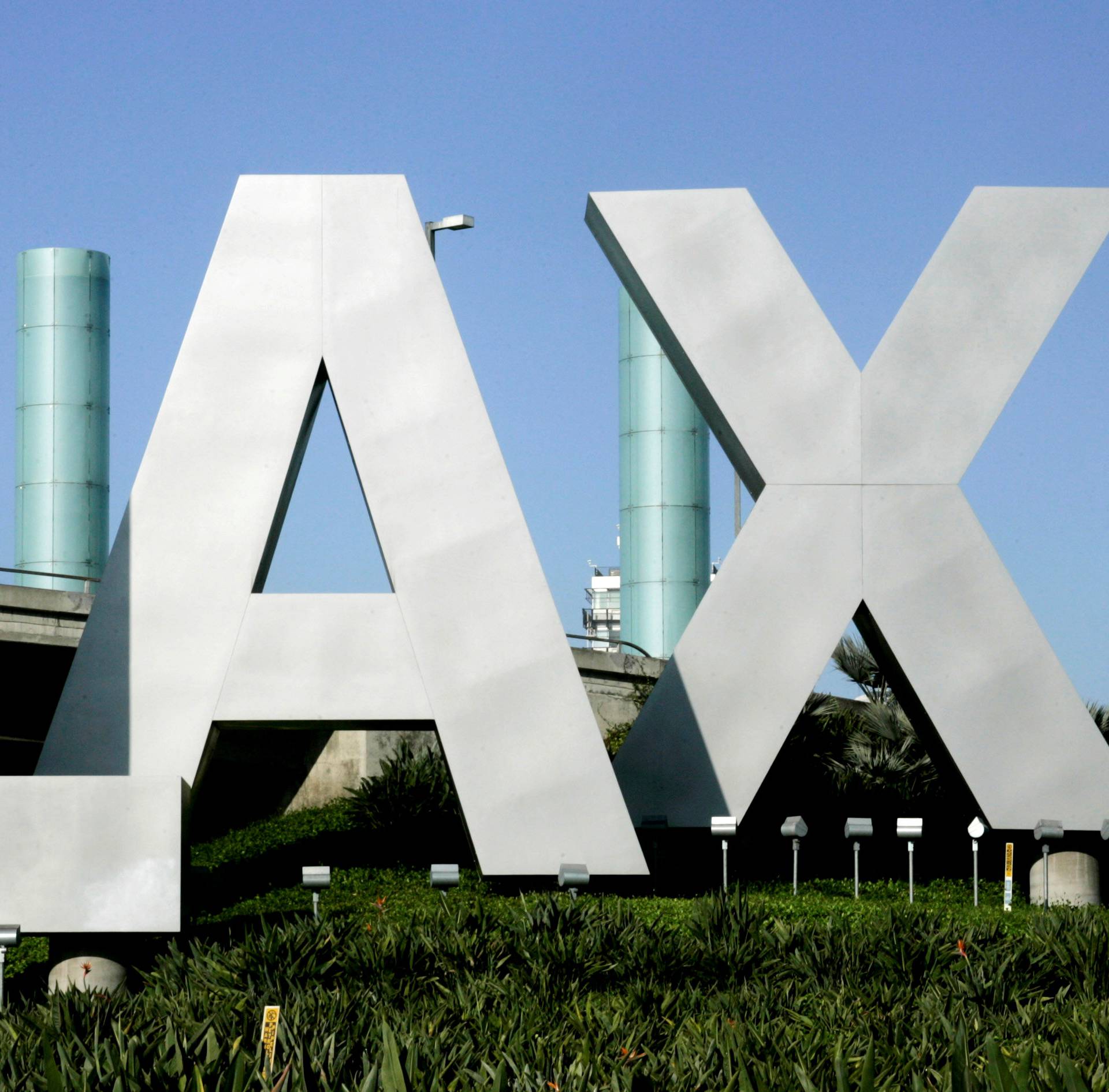 Giant stainless steel letters forming LAX are shown at the entrance way to Los Angeles International