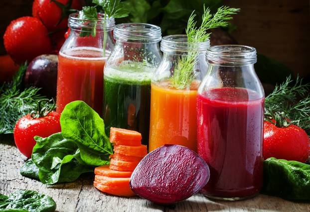 Four kind of vegetable juices: red, burgundy, orange, green