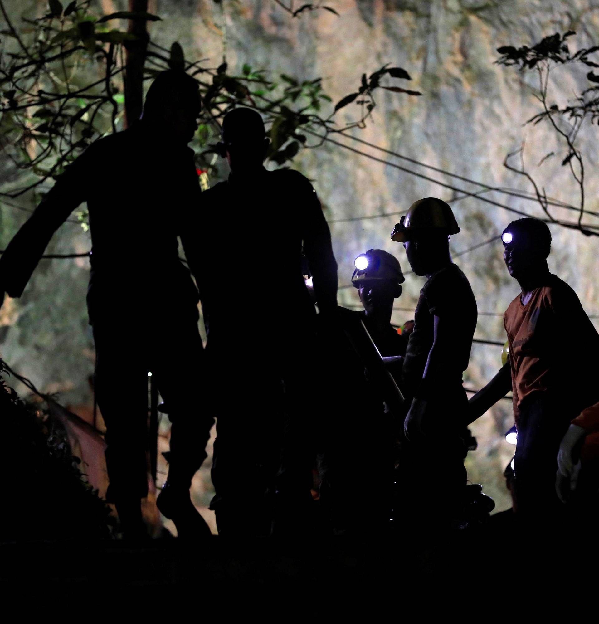 Rescue workers take a rest as they take out machines after 12 soccer players and their coach were rescued in Tham Luang cave complex in the northern province of Chiang Rai