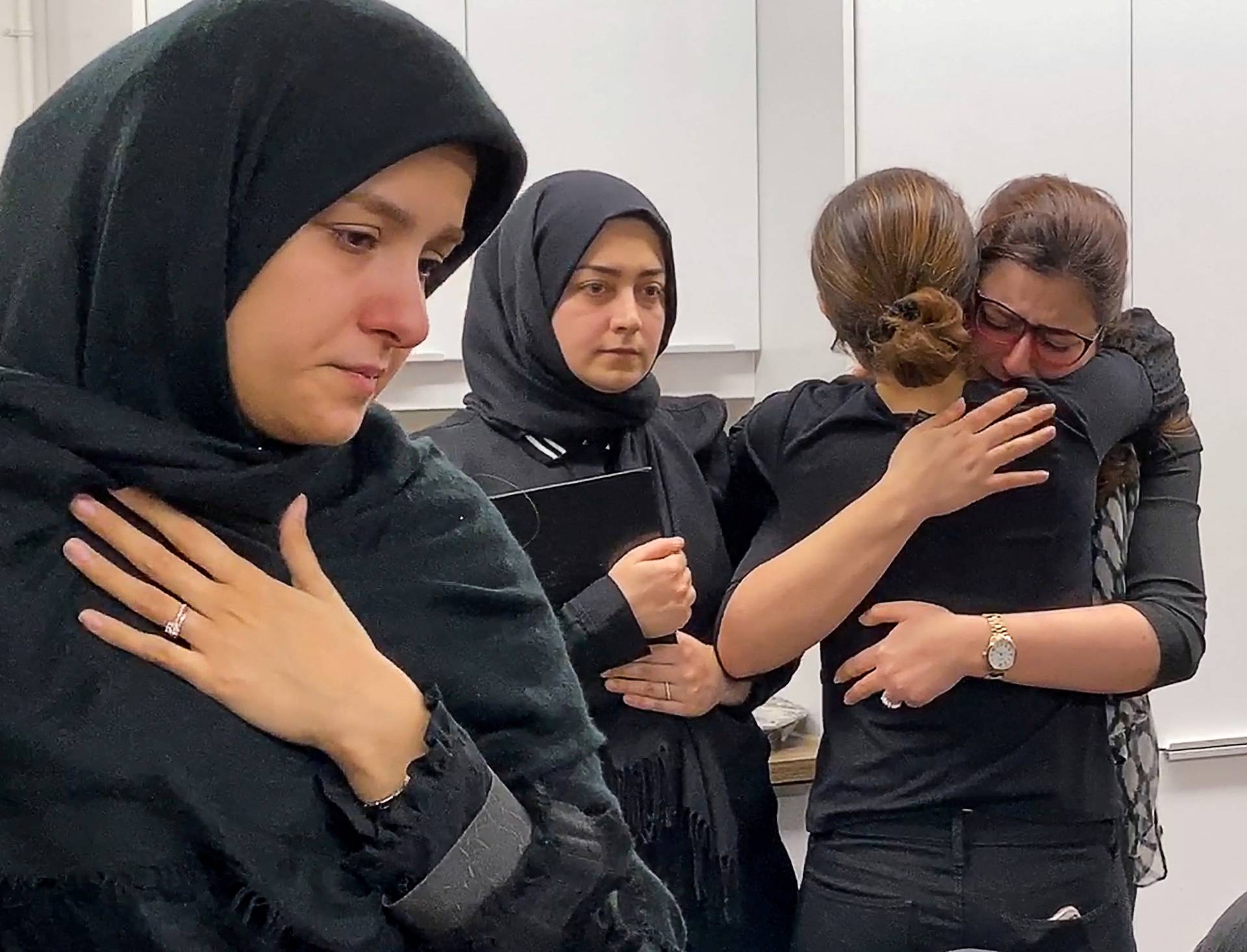 Mourners attend a vigil at University of Toronto student housing for the victims of a Ukrainian passenger jet which crashed in Iran