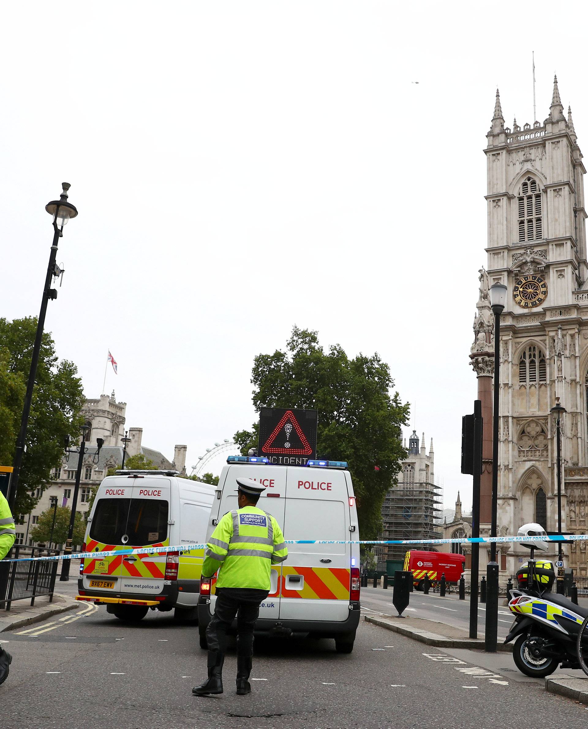 Police officers stand at a cordon after a car crashed outside the Houses of Parliament in Westminster, London
