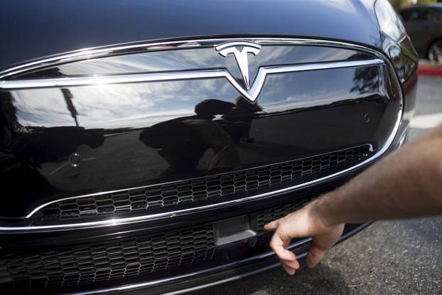 The radar technology of a Tesla Model S being pointed out during a Tesla event in Palo Alto