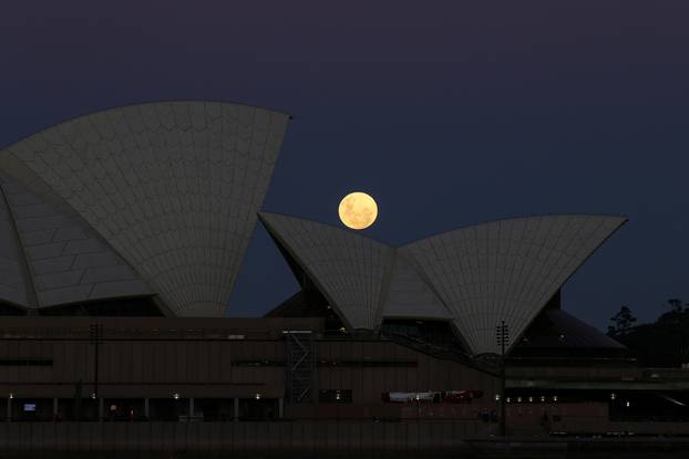 A Super Flower Moon rises behind the Sydney Opera House in Sydney