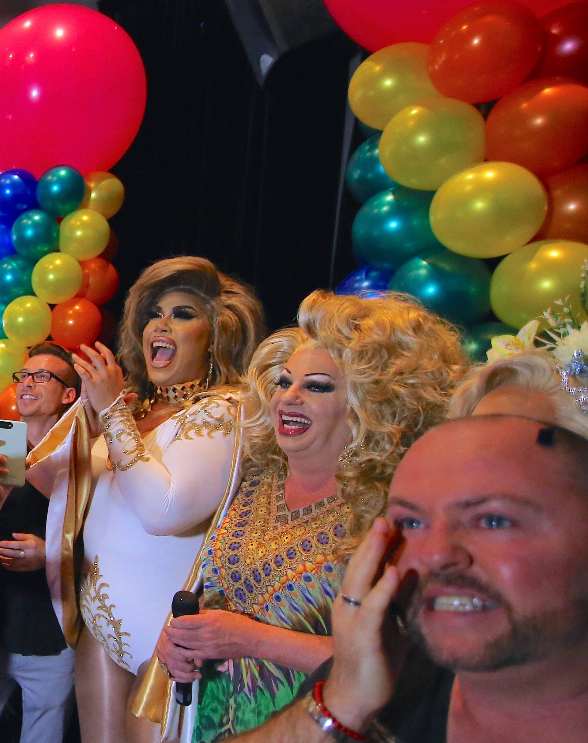 Members of the Sydney's gay community react as they celebrate after it was announced the majority of Australians support same-sex marriage in a national survey, at a pub located on Sydney's Oxford street