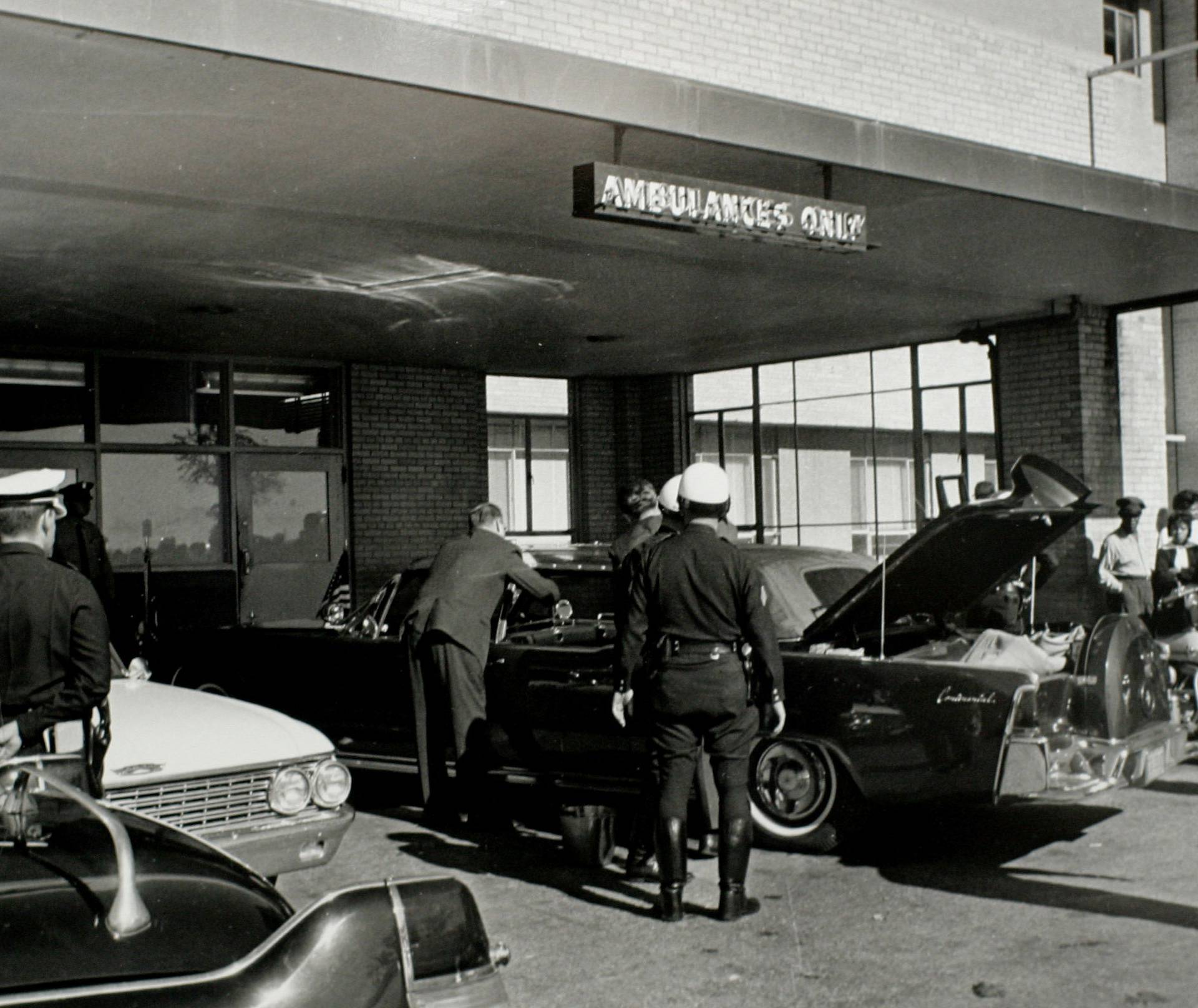 FILE PHOTO: U.S. Secret Service agents and local police examine the presidential limousine as it sits parked at Parkland Memorial Hospital in Dallas