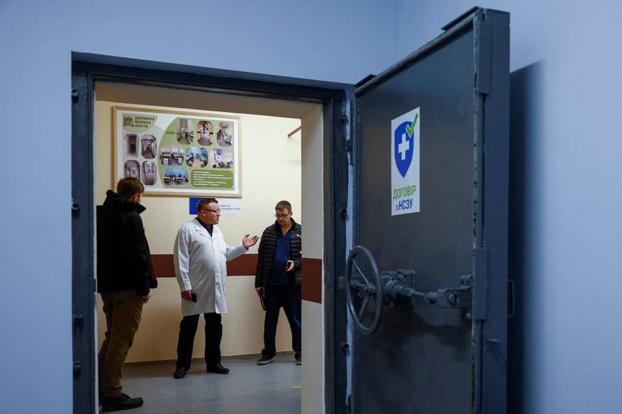 Chief doctor Viktor Korolenko speaks to his colleague inside a part of a hospital situated in an underground shelter in Kherson