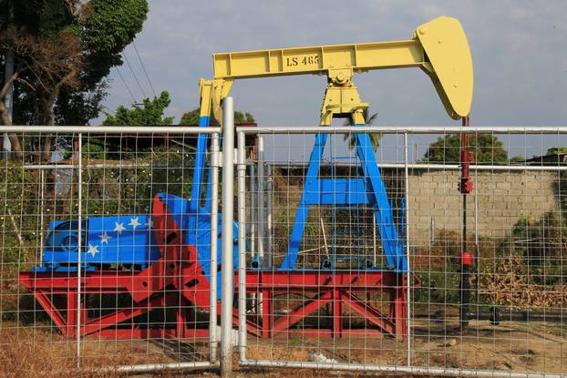 An oil pumpjack painted with the colors of the Venezuelan flag is seen in Lagunillas