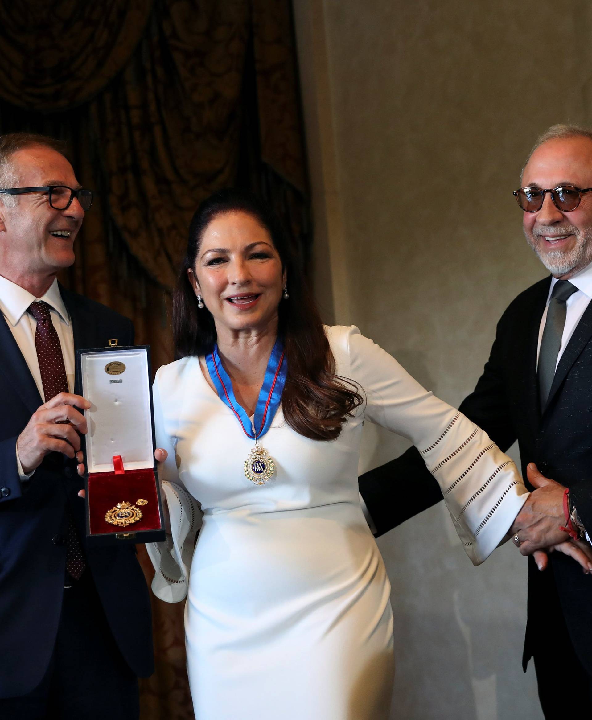 Cuban-American singer Gloria Estefan gets her husband Emilio Estefan to pose with her and Spain's Culture Minister Jose Guirao Cabrera after being awarded with Spain's Gold Medal of Merit for the Arts in Madrid