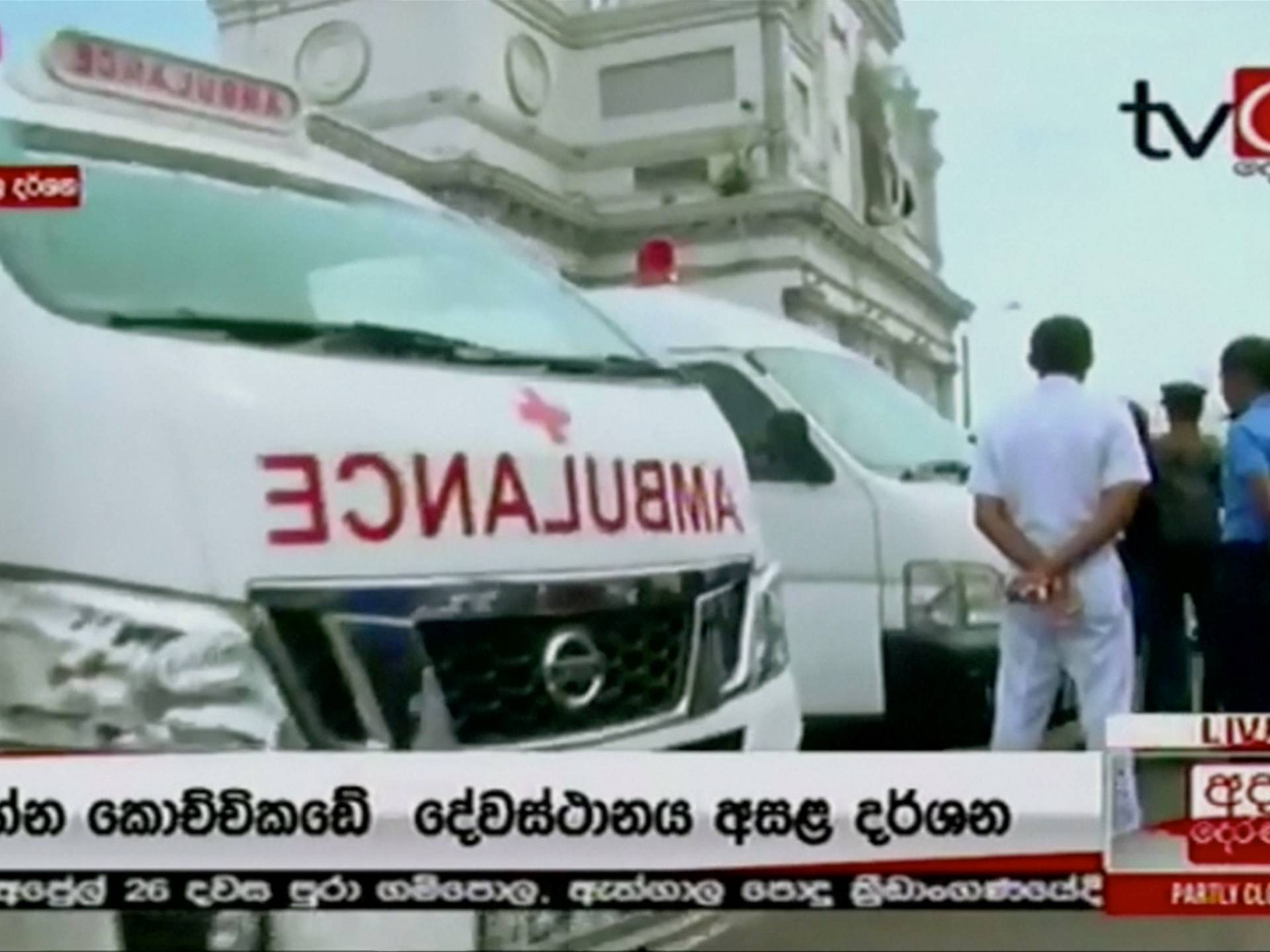 Ambulances wait outside St Anthony's church after explosions hit churches and hotels in Colombo