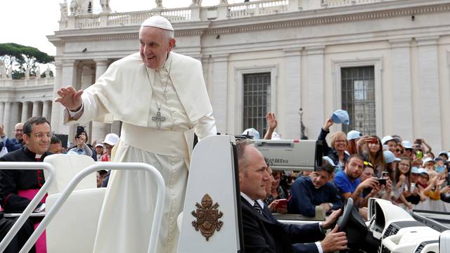 Pope Francis waves as he arrives to lead the Wednesday general audience in Saint Peter's square at the Vatican