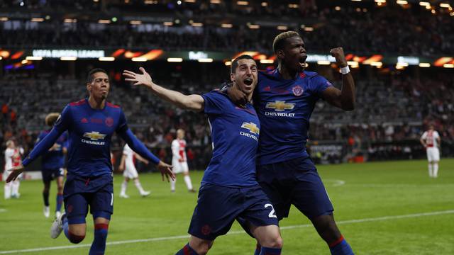 Manchester United's Henrikh Mkhitaryan celebrates scoring their second goal with Paul Pogba and Chris Smalling