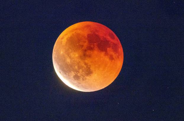 The "Blood Moon" is seen during a total lunar eclipse, from Bourg-en-Lavaux