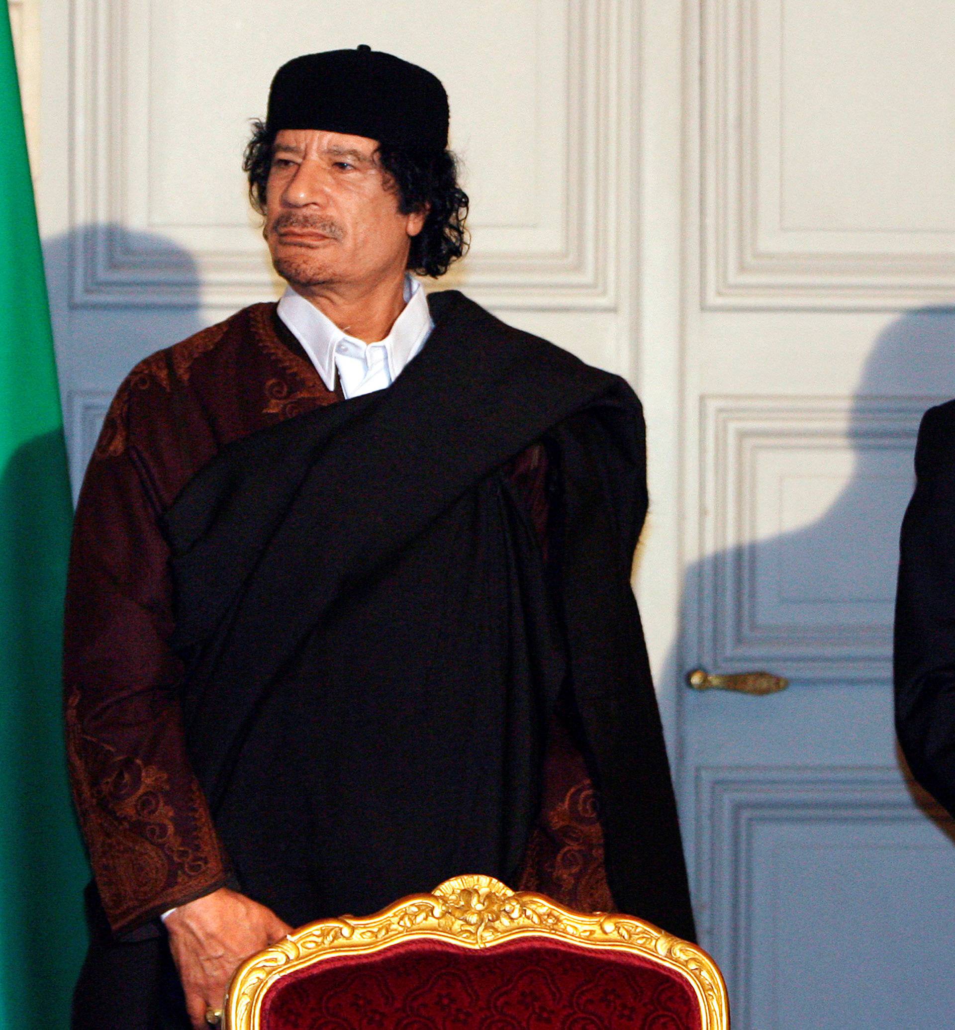 FILE PHOTO: France's President Nicolas Sarkozy and Libyan leader Muammar Gaddafi leave the room after the signature of 10 billion euros of trade contracts in Paris