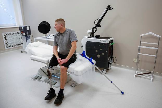 Former Ukrainian serviceman, who was wounded at a front line, comes to a clinic to treat scars, in Kyiv