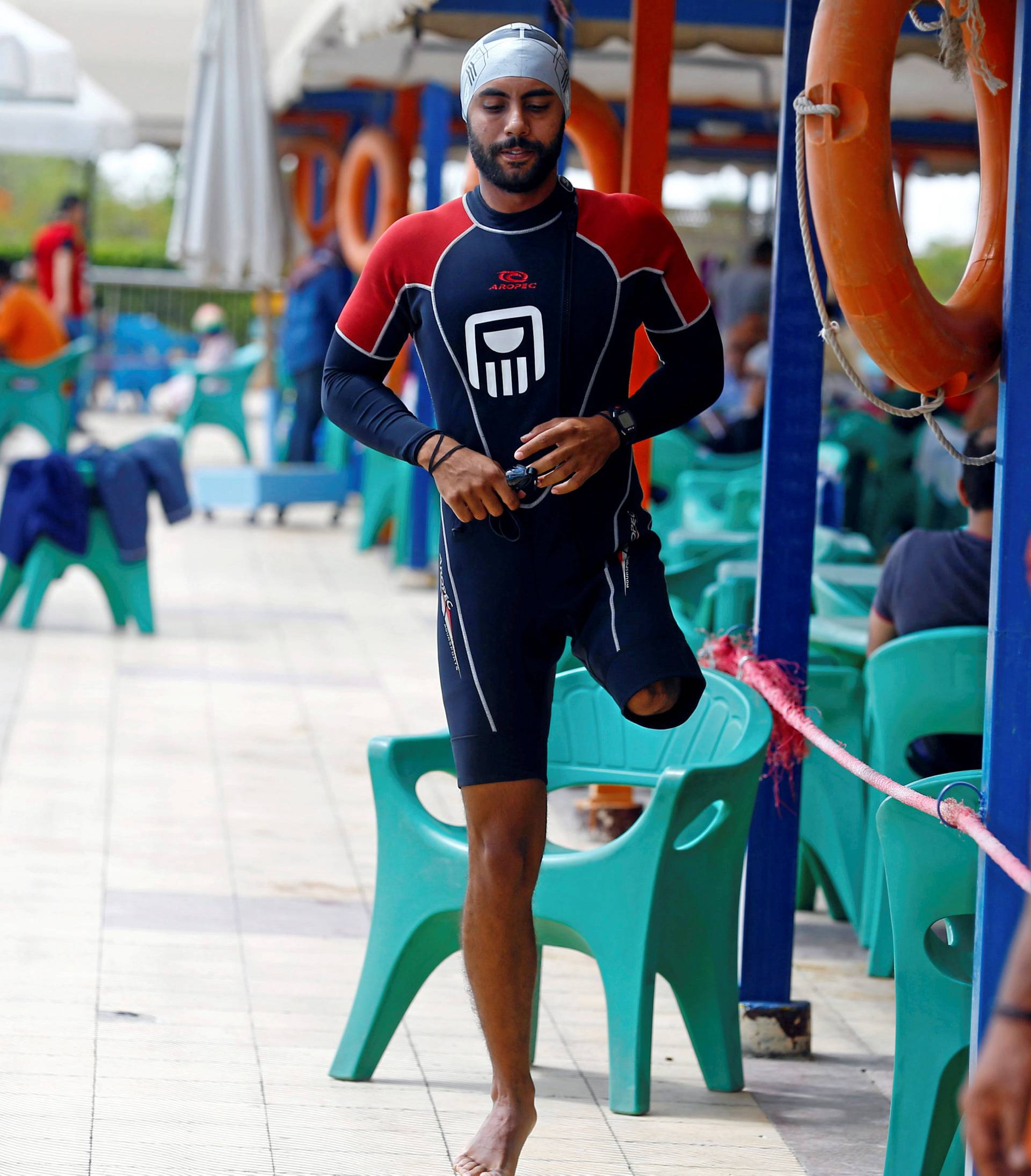 Egyptian swimmer Omar Hegazy, who is the first one-legged man to swim across the Gulf of Aqaba from Egypt to Jordan, before jumping into a swimming pool for practice in Cairo