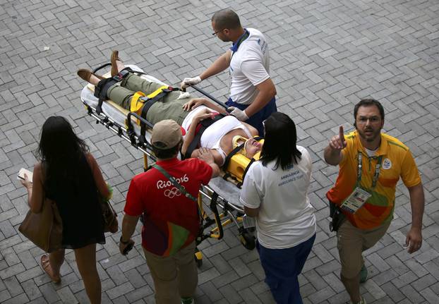 A woman is transported to an ambulance after being hit by an overhead television camera in Rio de Janeiro