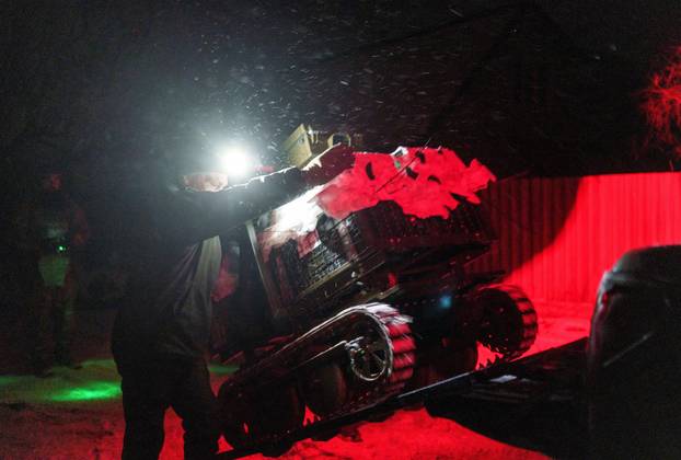 Ukrainian servicemen operate an unmanned ground vehicle fit for delivery missions on the frontline in Donetsk region