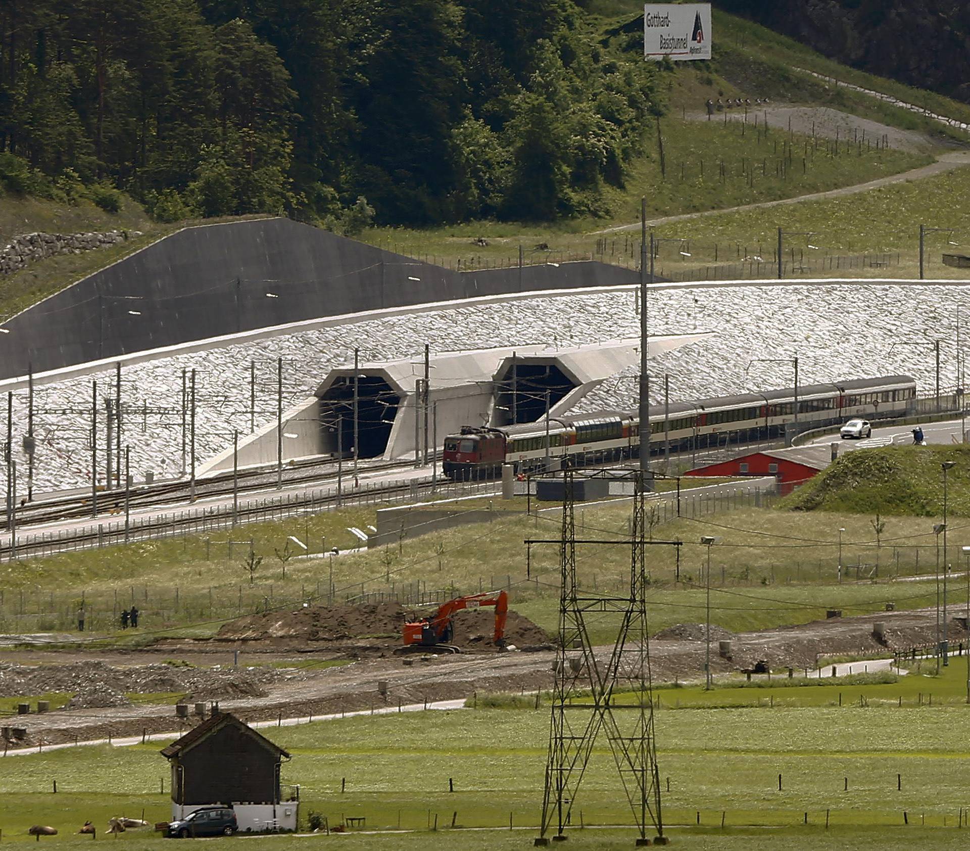 A train drives past the northern gates of the NEAT Gotthard Base Tunnel near Erstfeld