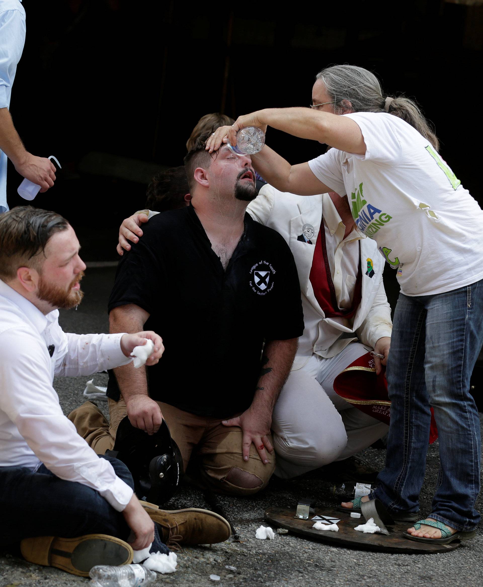 Members of white nationalist protesters receive first-aid during a clash against a group of counter-protesters in Charlottesville