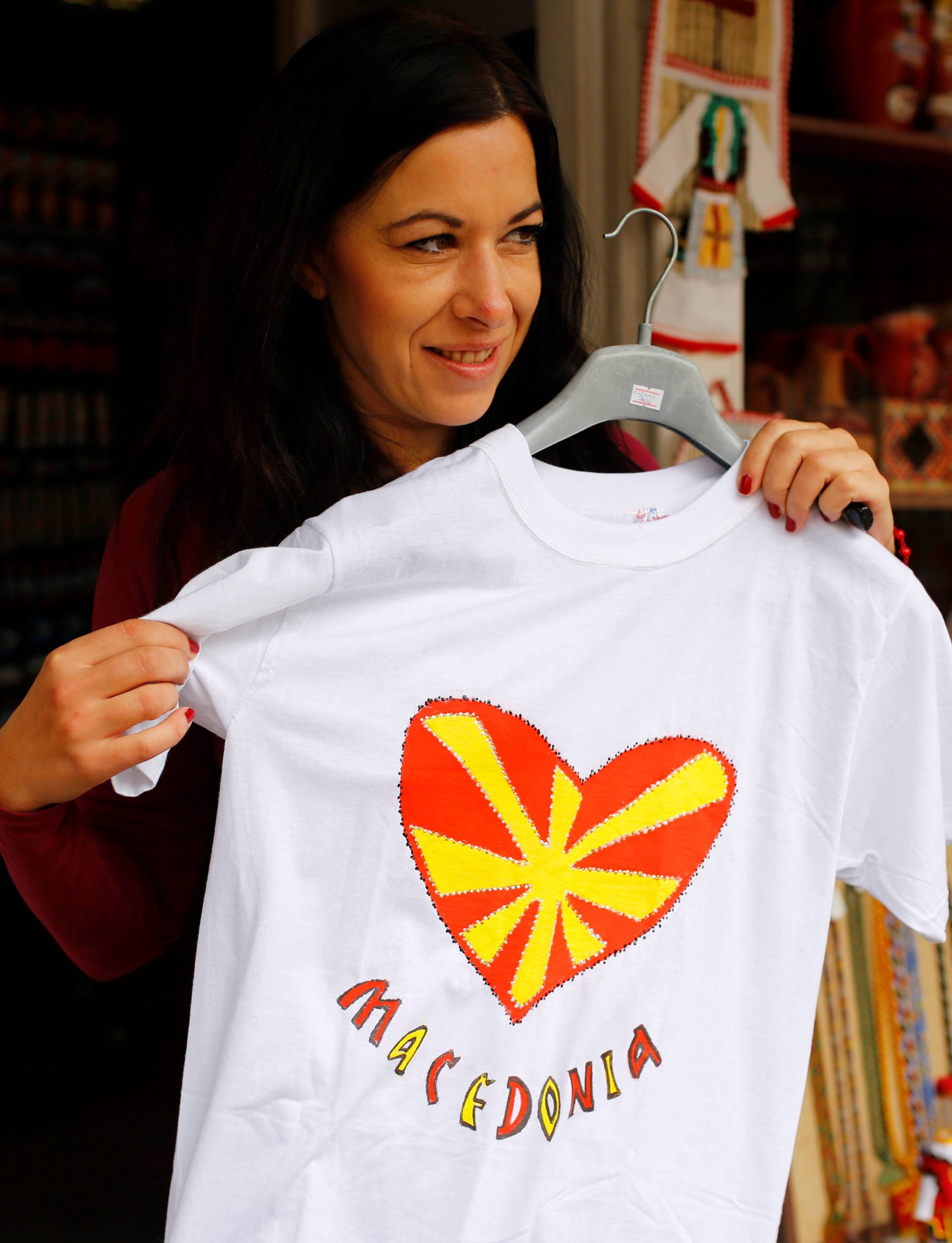 Tourists look at souvenirs with Macedonian flag on at the Old Bazar in Skopje