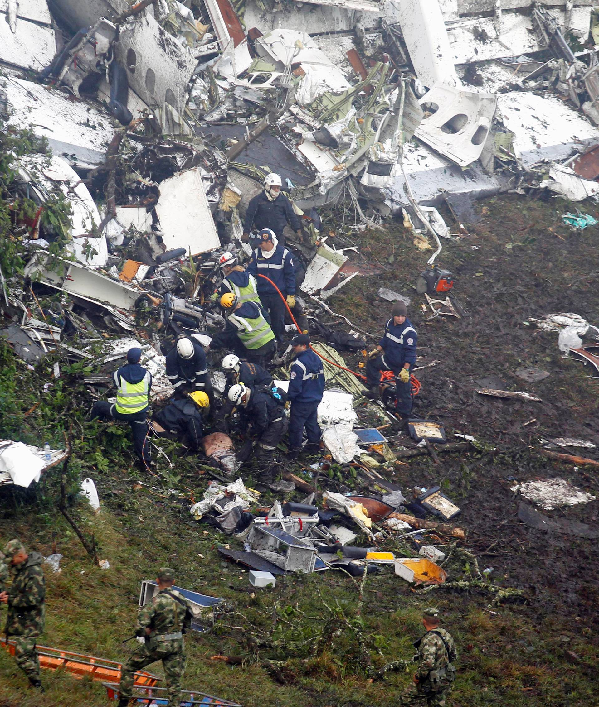 Rescue crew work in the wreckage from a plane that crashed into Colombian jungle with Brazilian soccer team Chapecoense, seen near Medellin